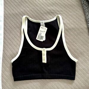 Black and white sports/lounge bra. Size S/M. New with tags.